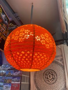 a large orange lamp hanging from the ceiling