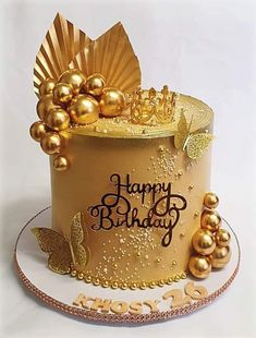 a birthday cake with gold decorations on top