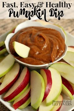 a white plate topped with sliced apples and an apple dip