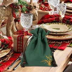 a table set for christmas with plates and napkins