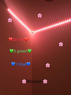 a room with flowers and hearts on the wall next to a light that reads red, 3 green, 1 blue