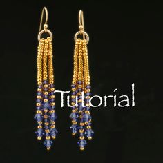 earrings with beads hanging from them on a black background