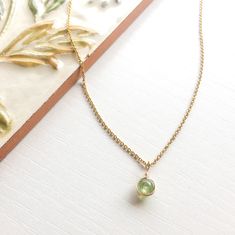 This beautifully simple necklace is lovingly handmade with a tiny Peridot gemstone and a choice of 14k Gold Filled, 14k Rose Gold Filled or Sterling Silver Chain. M A T E R I A L S: * Peridot * 14k Gold Filled, 14k Rose Gold Filled or Sterling Silver Chain S I Z E: *  Gemstones - Approximately 4mm *  Chain Thickness - Approximately 1.1mm  All of our jewellery is carefully handmade using good quality materials and handpicked gemstones, with the aim to produce quality pieces that you can love & wear for years to come.  P E R I D O T: * August Birthstone * Talisman for Gemini, Leo, Virgo, Scorpio, Sagittarius  * Heart Chakra, Solar Plexus Chakra Peridot is a powerful cleanser.  It alleviates jealousy, resentment, spite, bitterness, irritation, hatred and greed.  Reduces stress, anger and guil Dainty May Birthstone Gemstone Necklaces, Delicate Green Necklace With May Birthstone, Delicate Green May Birthstone Necklace, Round Peridot Birthstone Necklace, Delicate May Birthstone Necklaces For Her, Delicate Necklace With May Birthstone, Delicate May Birthstone Gemstone Necklace, Delicate Green Birthstone Necklace For Gift, Delicate Green Birthstone Necklace