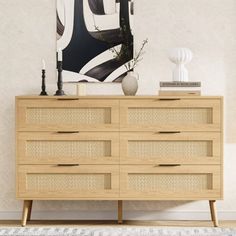 a wooden dresser sitting in front of a painting on the wall next to a rug