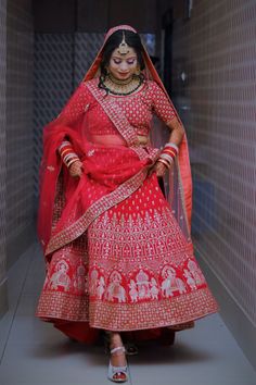 a woman in a red and white bridal outfit