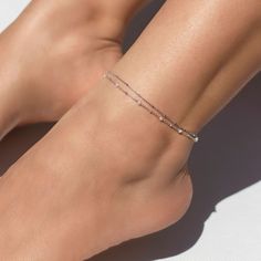 Add some sparkle to your ankle with this dainty anklet. Tiny Diamond cut beads on a delicate chain make it sparkle in the light. .925 Sterling Silver Italian Diamond Cut Chain, 1mm Hypoallergenic, lead and nickel free Length: 9-10in (23-25.3cm) Chain Thickness 1mm Lobster clasp closure Handcrafted in NYC #ANK043 Cheap Trendy White Anklets, Cheap Elegant White Anklets, Rose Gold Chain Anklet, Cheap Elegant Ankle Strap Anklets, Cheap Wedding Anklets For Women, Affordable Wedding Anklets For Women, Adjustable Minimalist Anklets, Cheap Dainty Anklets For Summer, Dainty Anklets As Gifts