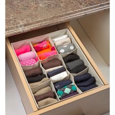 an open drawer with several pairs of socks in it