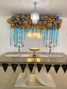 a table with balloons and decorations on it