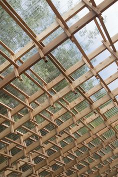 the inside of a wooden structure with lots of wood slats hanging from it's ceiling