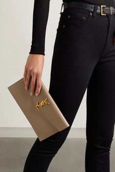 SAINT LAURENT's 'Uptown' pouch fits everything you need for an evening at a gallery opening or rooftop bar. It's been made in Italy from textured-leather and decorated with the iconic 'YSL' hardware in gold hardware. Carry it in hand or slip it inside one of the brand's bags. Ysl Uptown Pouch Outfit, Ysl Uptown Pouch, Saint Laurent Pouch, Ysl Pouch, 2023 Handbags, Saint Laurent Jewelry, Gallery Opening, Saint Laurent Bags, Ysl Logo