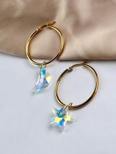 Are you looking for the perfect star and moon hoop earrings for someone special this gifting season? Or a unique pair of gold celestial earrings to spoil your bestie or significant other? Made with tarnish-free stainless steel and dazzling Aurora Borealis crystal charms, my asymmetrical gold hoops are the perfect compliment to any outfit idea! My crystal star earrings are a great gift idea for any special occasion to all the women in your life. You can't go wrong when gifting my celestial earrin Earrings Gold Hoops, Celestial Earrings, Crescent Earrings, Earrings Star, Moon And Star Earrings, Asymmetrical Earrings, Star And Moon, Ringe Gold, Crystal Hoop Earrings