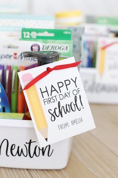 a teacher's day box with pens, pencils and markers in it that says happy first day of school