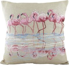 pink flamingos are standing in the water on a beige pillow