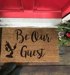 a door mat that says be our guest