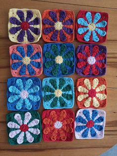 nine crocheted squares are arranged on a wooden surface, each with different colored flowers