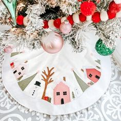 a christmas tree skirt with ornaments on it