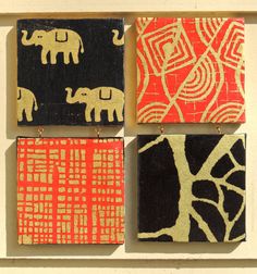 four square paintings with elephants on them are hanging from the side of a white wall