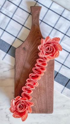 a wooden cutting board with flowers on it