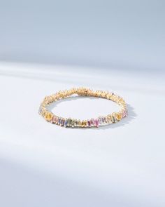 The Bold Pastel Sapphire Tennis Bracelet, set with 9.38 carats of baguette-cut pastel sapphires, offers a delightful daily burst of sparkle. Its sleek and curved silhouette makes it an essential fashion piece for any collection, effortlessly complementing various styles. Designed for versatility, this bracelet is ideal for stacking, allowing you to create a personalized look with ease. Details 18k yellow gold or rose gold 9.38 carats of pastel sapphires baguettes Bracelet measures 7 inches in length Box clasp with safety lock fastening 6mm width Ref: AKB403 Multicolor Multi-stone Round Tennis Bracelet, Luxury Sapphire Yellow Gold Tennis Bracelet, Gold Multi-stone Tennis Bracelet For Formal Occasions, Gold Multi-stone Tennis Bracelet, Elegant Multicolor Multi-stone Tennis Bracelet, Essential Fashion Pieces, Sapphire Tennis Bracelet, Baguette Bracelet, Essential Fashion