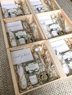 four wooden boxes filled with personal items on top of a carpeted floor next to each other