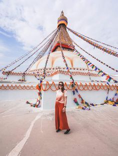 a woman standing in front of a large structure