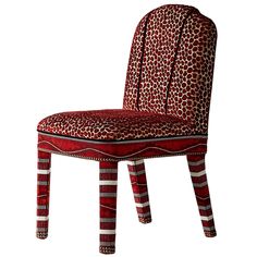 a red and white patterned chair with an animal print upholstered on the back