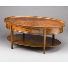 an oval coffee table with two drawers on each side and one drawer at the top