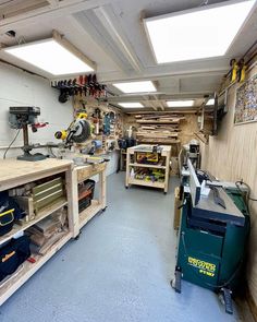 the inside of a garage with lots of workbench and tools on it's walls