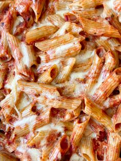 a close up view of some pasta with sauce and cheese