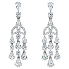 Sweet and sultry, the Eterna Diamond Earrings are a delicate yet impactful pair. They are a classic that can be worn to impress on a casual evening out or for a more stated look. Diamonds Shape: Pear Shape & Round Side Diamonds Weight: 4.21 ct Side Diamond Color: H - I Side Diamond Clarity: VS (Very Slightly Included) Metal: 14K White Gold Metal Wt: 9.13 gms Setting: Prong Set Length: 1.73 Inches (4.4 cm) Non Threaded Post & Push Back Closure Vintage Drop Earrings, Casual Evening, Look Plus, Diamond Clarity, Pear Shaped, Diamond White, Diamond Shapes, Prong Setting, Colored Diamonds