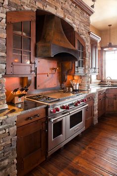 a large kitchen with an oven, stove and sink in it's center island