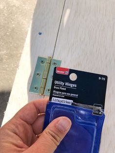 a hand holding a blue plastic card holder