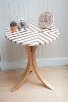 a small table with a potted plant next to it