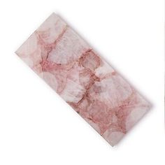 a piece of pink marble sitting on top of a white table