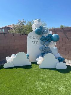 balloon arch with blue and white balloons in the shape of clouds