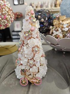 a small white christmas tree made out of buttons