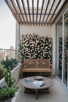 a wooden bench sitting on top of a patio next to a flower filled planter