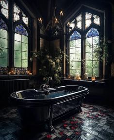 a bath tub sitting in front of two windows with rose petals on the floor next to it