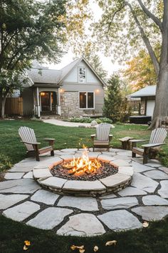 Backyard with a stone fire pit and four chairs, with a house in the background surrounded by trees. Outdoor Bbq Pit Ideas Backyards, Backyard Fire Pit Patio, Fire Pit For Small Backyard, Farm Fire Pit Ideas, Backyard Large Pavers Ideas, Backyard Patio And Fire Pit Ideas, Backyard Landscape Inspiration, Backyard Deck Fire Pit, Backyard With Fire Pit And Playground