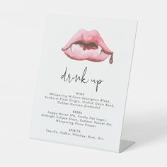 a card with the words drink up written in black ink on it and a pink lip