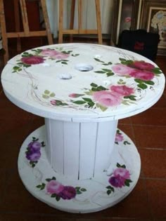 a white table with flowers painted on it