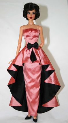 a barbie doll wearing a pink and black dress