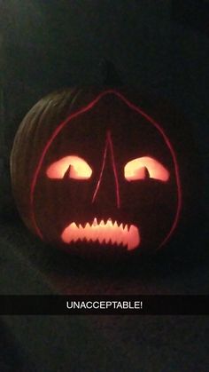 a carved pumpkin with glowing eyes and mouth