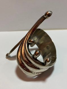 "This is an incredible, vintage Taxco sterling silver clamper bracelet that is Mid Century Moden MCM - from the 1950s. The bracelet is huge and features stunning sterling ball design. The inner circumference of the bracelet is about 7 1/4\" unopened as it is. It measures about 2 1/2\" by 2\" unopened. It is a clamper so it can fit a larger sized wrist. The hinge on the back of the bracelet is looser - not tight. This means the bracelet cannot adjust smaller, only larger. The two front pieces do Unique Sterling Silver Bracelet For Anniversary, Unique Silver Cuff Bracelet For Anniversary, Vintage Sterling Silver Bracelet As Gift, Vintage Sterling Silver Bangle In Antique Silver, Vintage Silver Bangle For Anniversary, Unique Anniversary Bangle, Vintage Nickel Free Silver Cuff Bracelet, Antique Silver Bangle For Anniversary, Silver Bracelet Gift