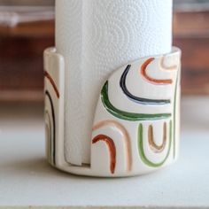 a roll of toilet paper sitting on top of a white counter