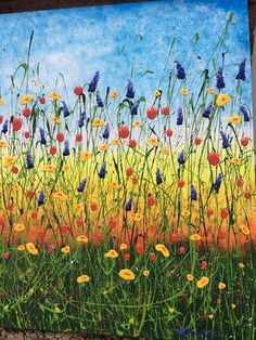 a painting of wildflowers and blue sky