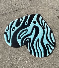 a blue and black zebra print on the ground