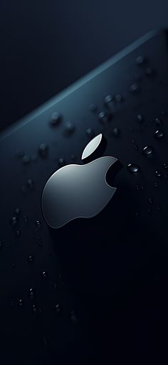 an apple logo is shown on the back of a black iphone with drops of water around it