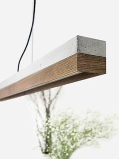 a wooden beam suspended over a planter filled with flowers