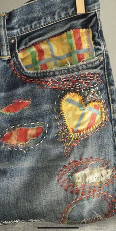 an old pair of jeans with patches on them